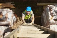 Worker climbing ladder