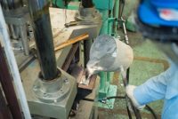 Operator pouring aluminum molten in to high precision casting mold